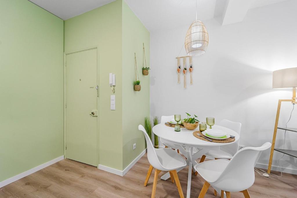 a white dining room with a white table and chairs at Green Living-Funchal in Funchal