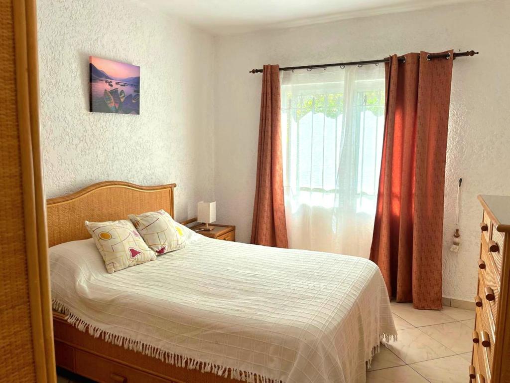 a bedroom with a bed and a window at 3 bedroom Ground Floor beach Flic en Flac in Flic-en-Flac