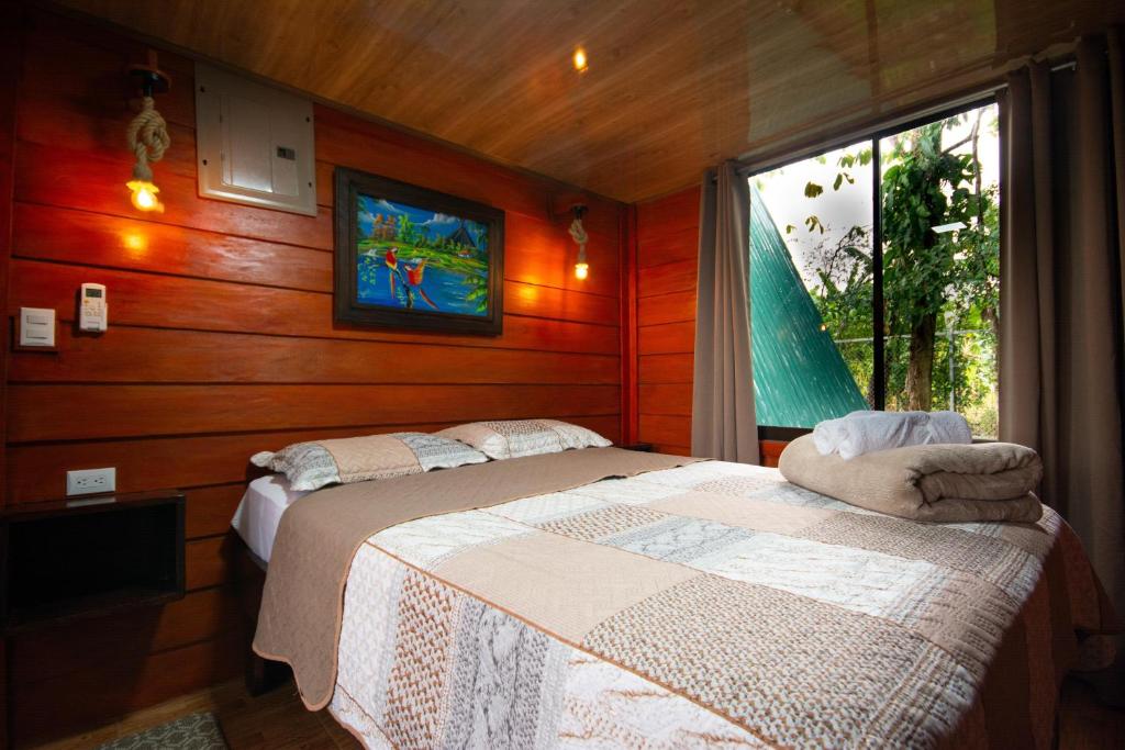 a bedroom with two beds and a tv on the wall at Betulio's Oasis in Fortuna