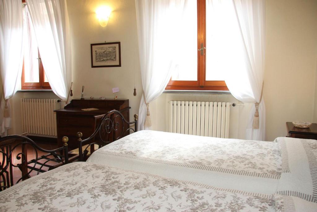 Postel nebo postele na pokoji v ubytování B&B L'Agnolo Di Caroti Cinzia