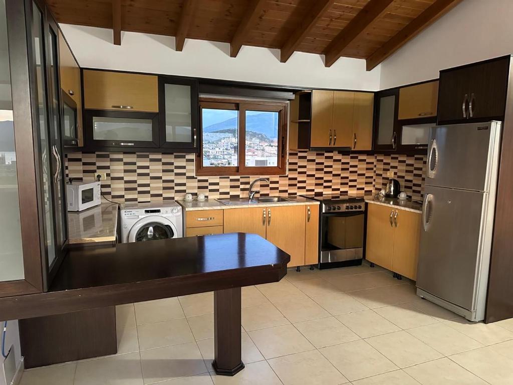 a kitchen with a washer and dryer in it at Hotel Marku in Ksamil