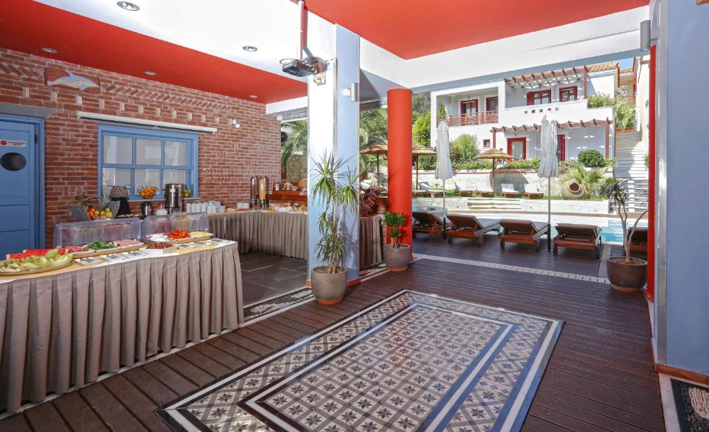 an outdoor patio with a table and a pool at Sirena Residence & Spa in Marathokampos