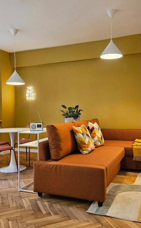 a living room with a couch and a table at Lovely Sparkly Apartment in Krakow