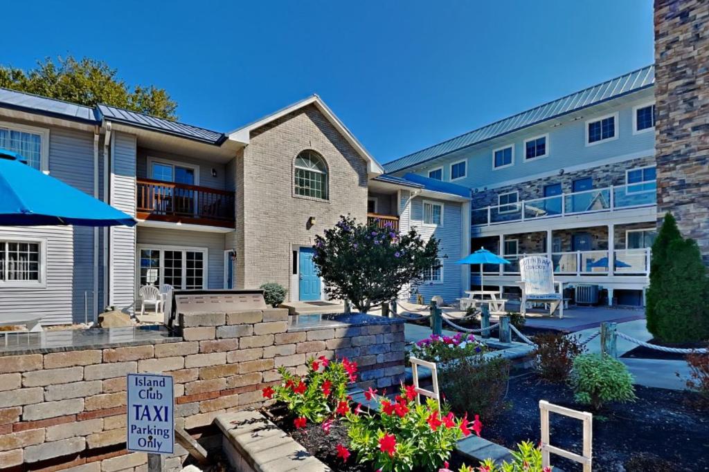 a building with a sign that says rental car inn at Put-in-Bay Poolview Condo #2 in Put-in-Bay