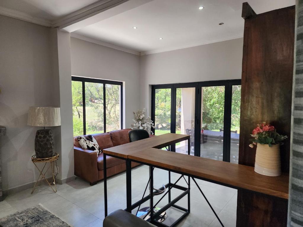 un soggiorno con un tavolo e un divano di Plot 5 on the Vaal a West End