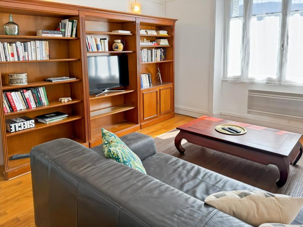 a living room with a couch and a coffee table at La maison Hortensias Vic-Sur-Cère - 4pers in Vic-sur-Cère