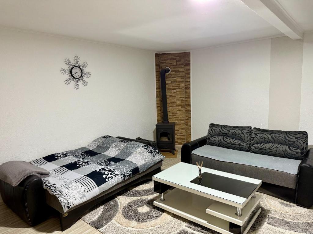 a living room with a bed and a couch at Kalinka Apartment in Bitola