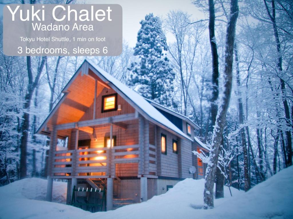 a book cover of a wooden cabin in the snow at Morino Chalets in Hakuba