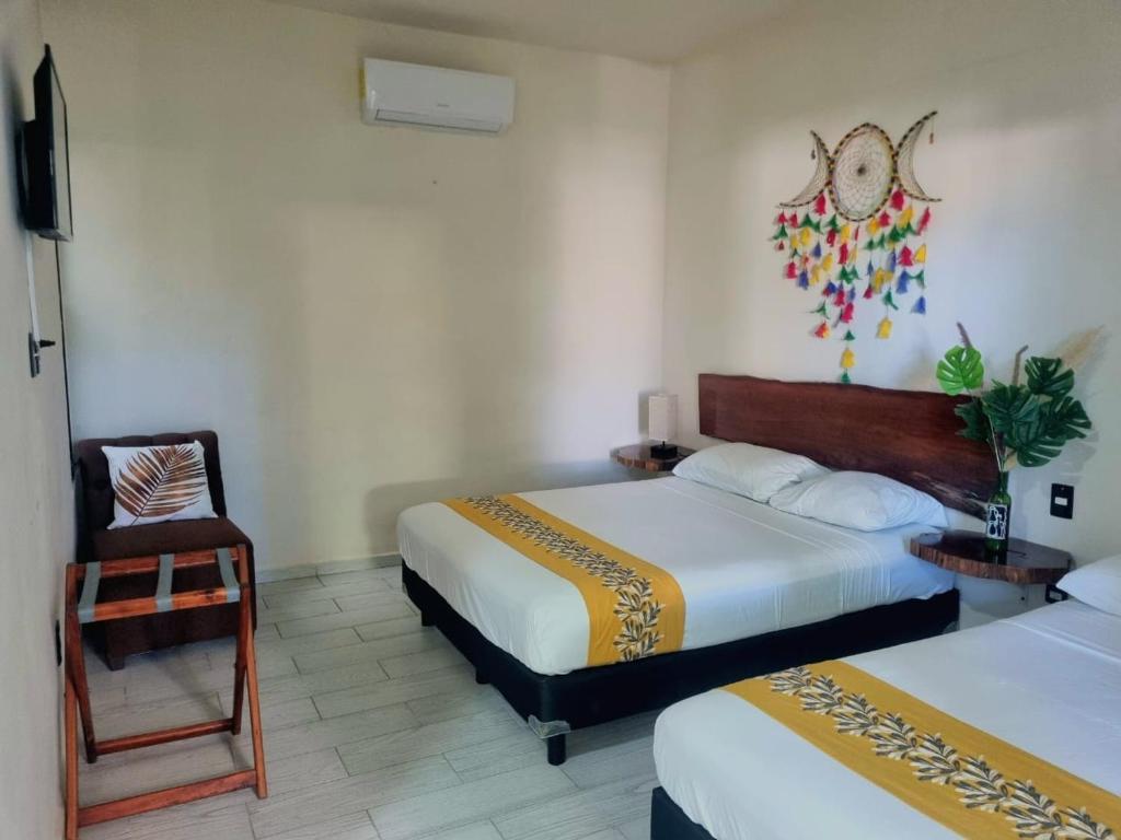 Postel nebo postele na pokoji v ubytování Hotel Brisas Bacalar