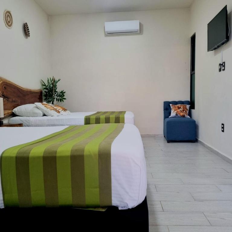 Postel nebo postele na pokoji v ubytování Hotel Brisas Bacalar