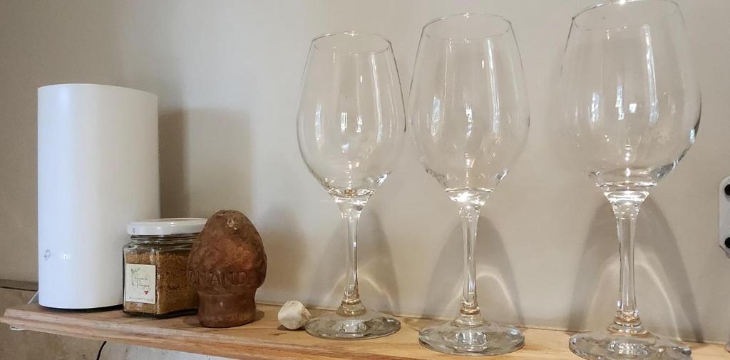 a group of wine glasses sitting on a shelf at Cabaña monoambiente en Bariloche 3 pax in San Carlos de Bariloche