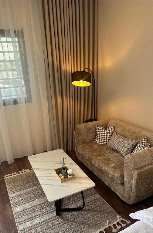 a living room with a couch and a coffee table at Quite Studio in Abha