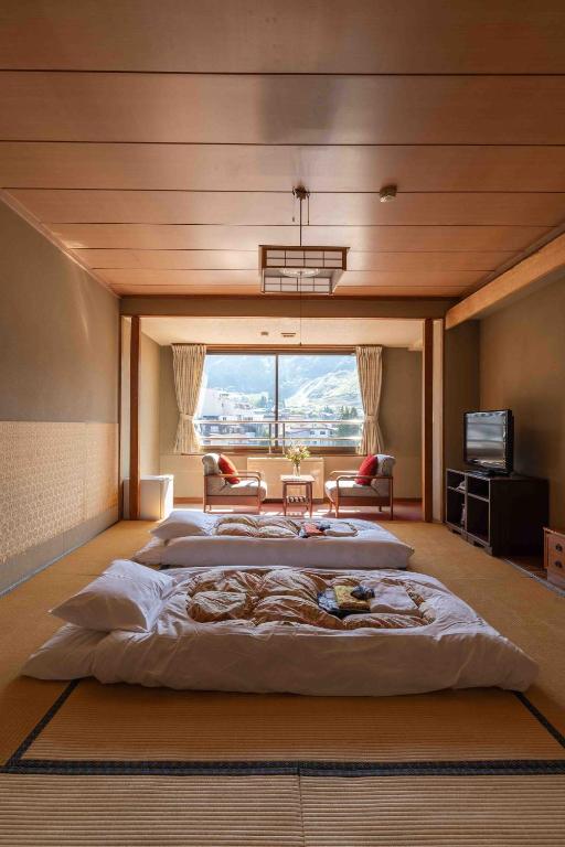 Postel nebo postele na pokoji v ubytování Nozawa View Hotel Shimataya