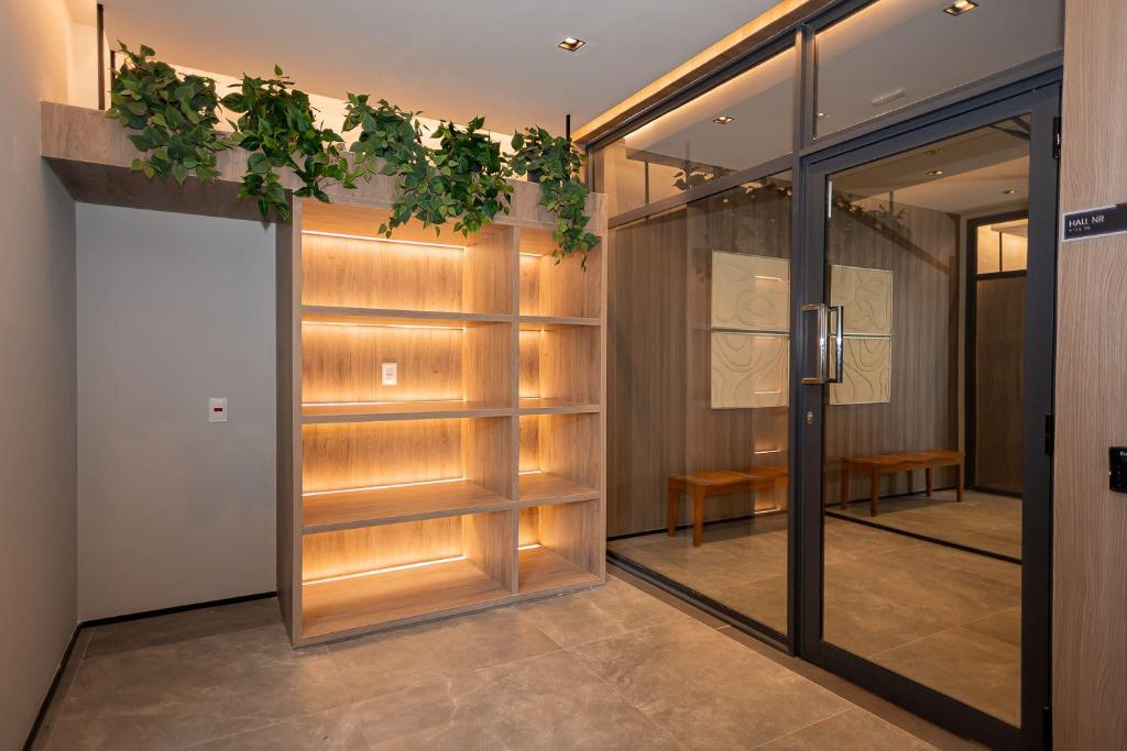 a walk in closet with wooden doors and plants at TD 110 Exclusivo Apartamento Na Vila Mariana, Poucos Metros do Metrô Vila Mariana ! in Sao Paulo