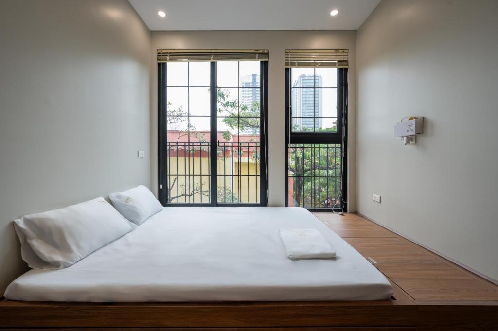 Postel nebo postele na pokoji v ubytování Hanoi Local Vibe Homestay