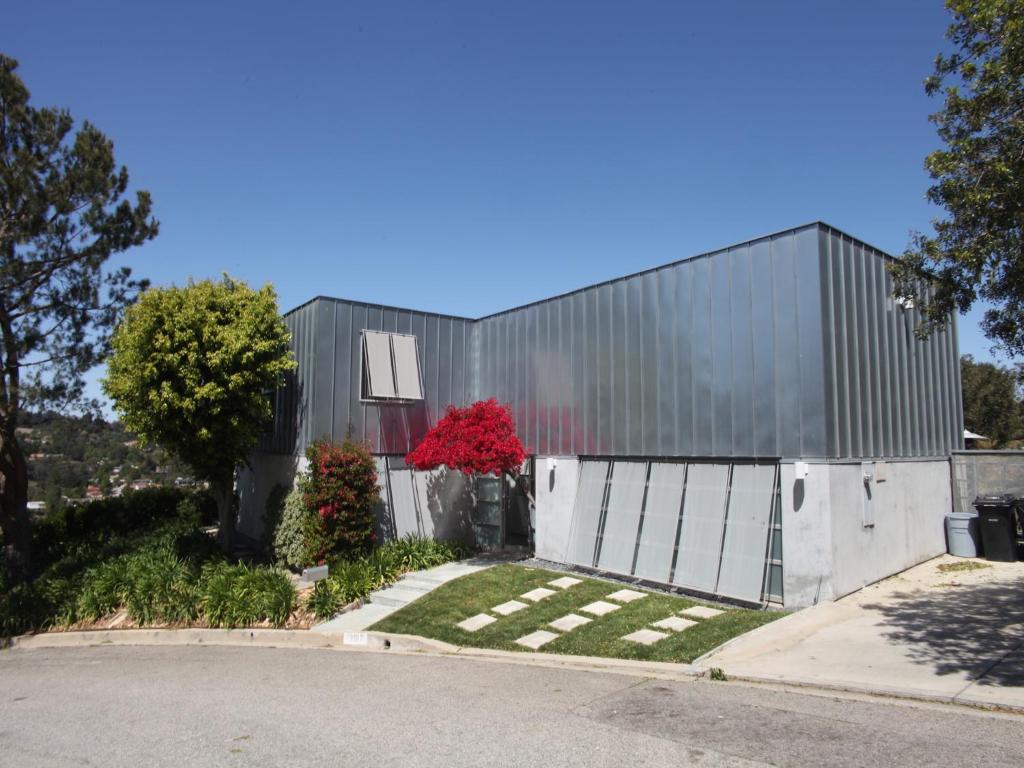 a building with a red tree in front of it at Silver Box Beverly Hills in Los Angeles