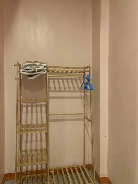 a ladder in a room with two blue vases at Liam's Homestay El Nido in El Nido