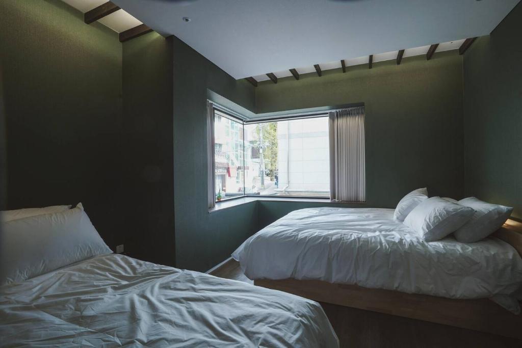 Postel nebo postele na pokoji v ubytování Boro Hanok Hostel in Myeongdong