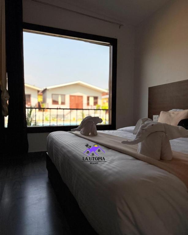 Postel nebo postele na pokoji v ubytování La Utopia Resort