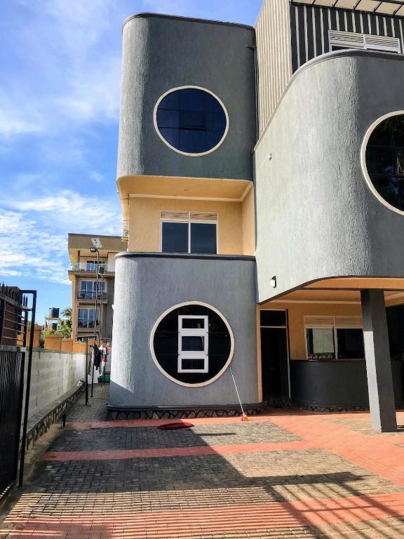 a building with a round window on the side of it at Yazmin's Bright Studio with Fast Wi-Fi & Parking in Kampala