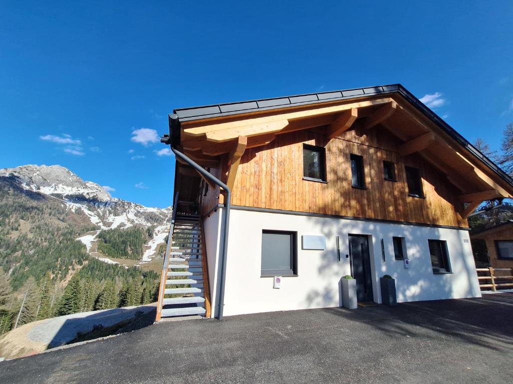 a building with a staircase on the side of it at Almhaus Hochenwarter in Sonnenalpe Nassfeld