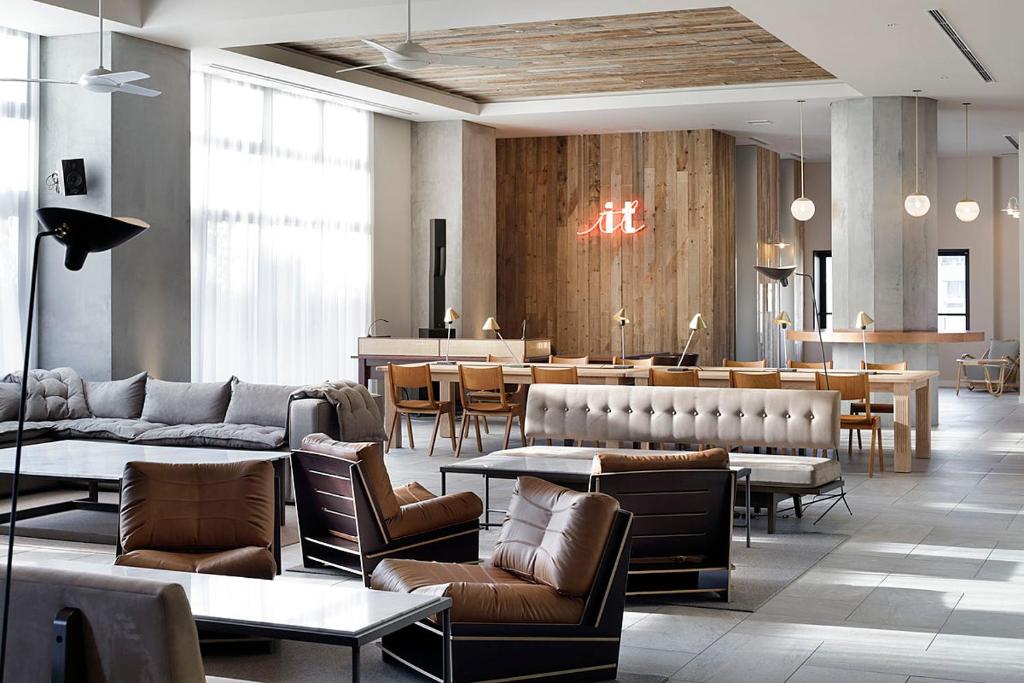 a restaurant with couches and tables and a bar at Hotel It Osaka Shinmachi in Osaka