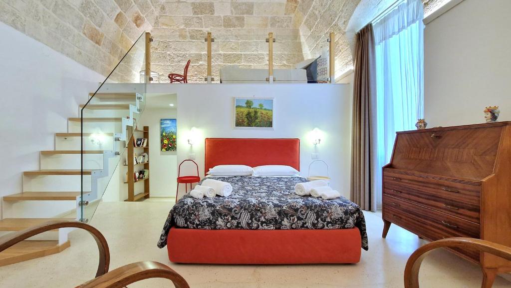 a bedroom with a bed and a staircase at MandorleOlio in Polignano a Mare