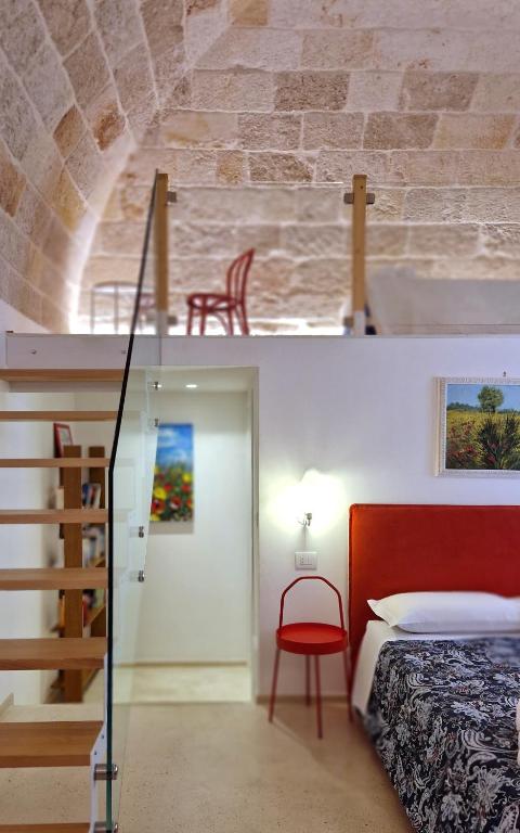 a bedroom with a bed and a staircase in a room at MandorleOlio in Polignano a Mare