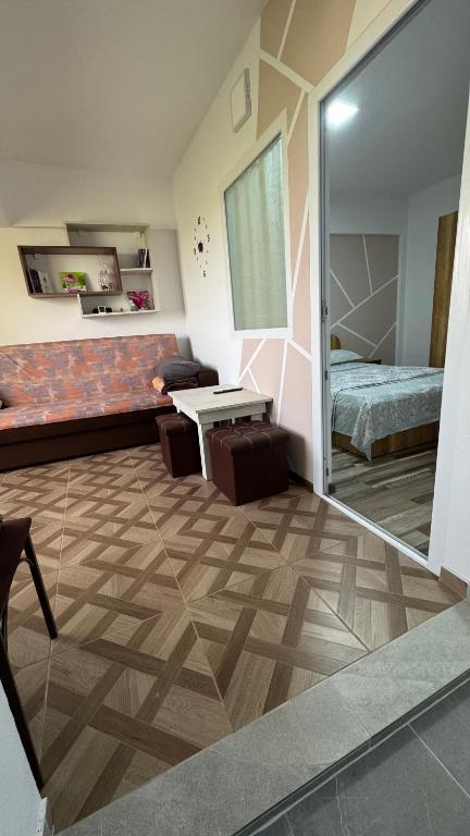 a living room with a couch and a bedroom at CoraHome Ultra Central in Corabia