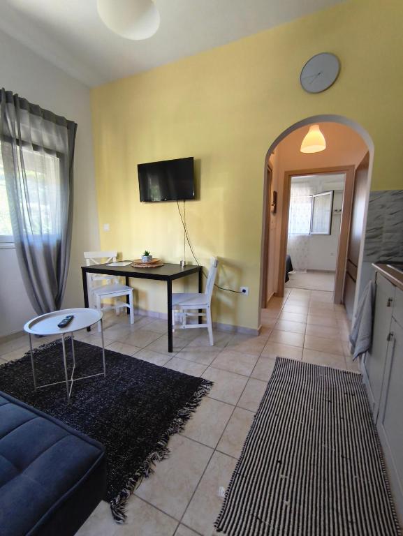 a living room with a couch and a table at Cozy apartment in Ialysos