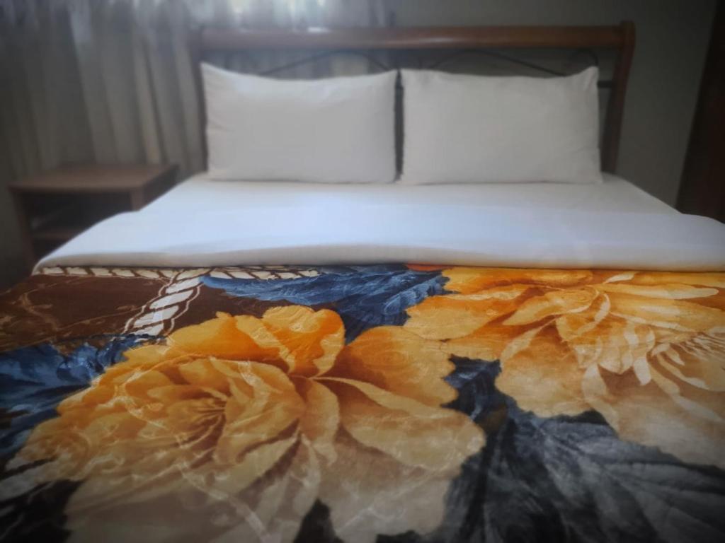 A bed or beds in a room at Snowdrop Resident