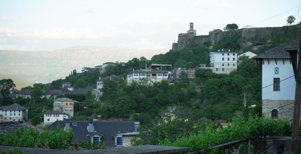 a town with a castle on top of a hill at Paris's Apartment in Gjirokastër