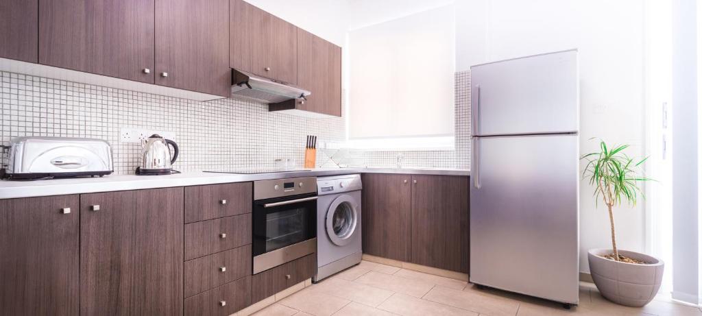Kuchyň nebo kuchyňský kout v ubytování Napian Suites