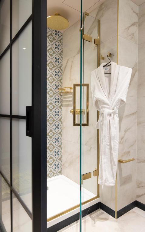 a dressing room with a white robe on a glass case at The Mercantile Hotel in Dublin