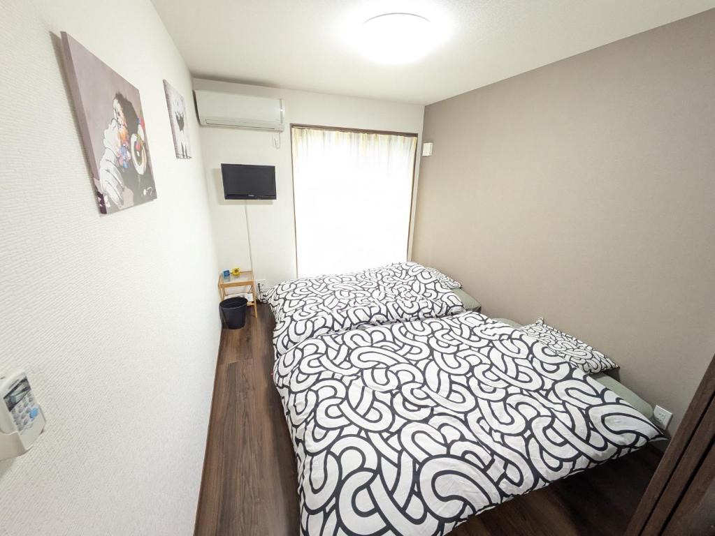 Postel nebo postele na pokoji v ubytování Nanba southエルメゾン3rd