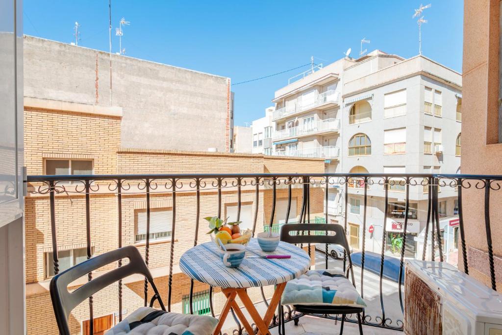 a balcony with a table and chairs on a balcony at Legado Marino in Santa Pola