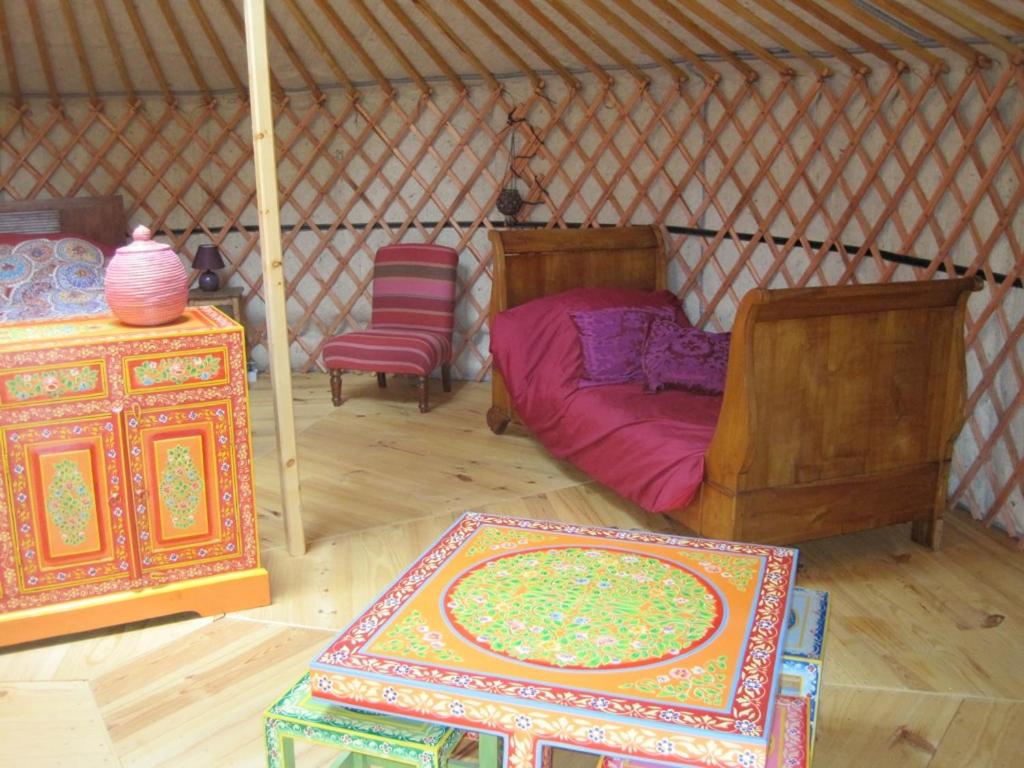 a room with a bed and a table in a yurt at Le Mas Nomade in Callian