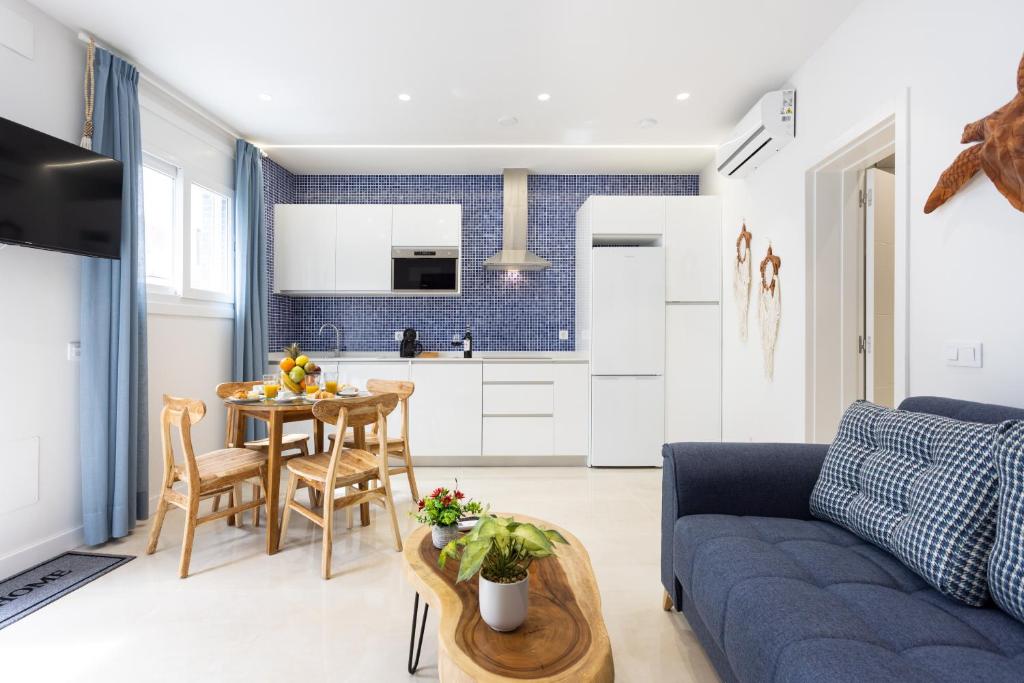 a living room with a blue couch and a table at La Tortuga Azul A in Puerto de la Cruz