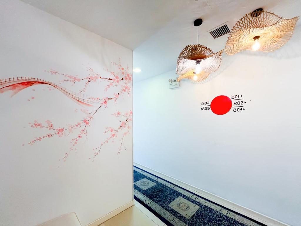 A decorated interior corridor with floral wall art, patterned carpet and room signage.