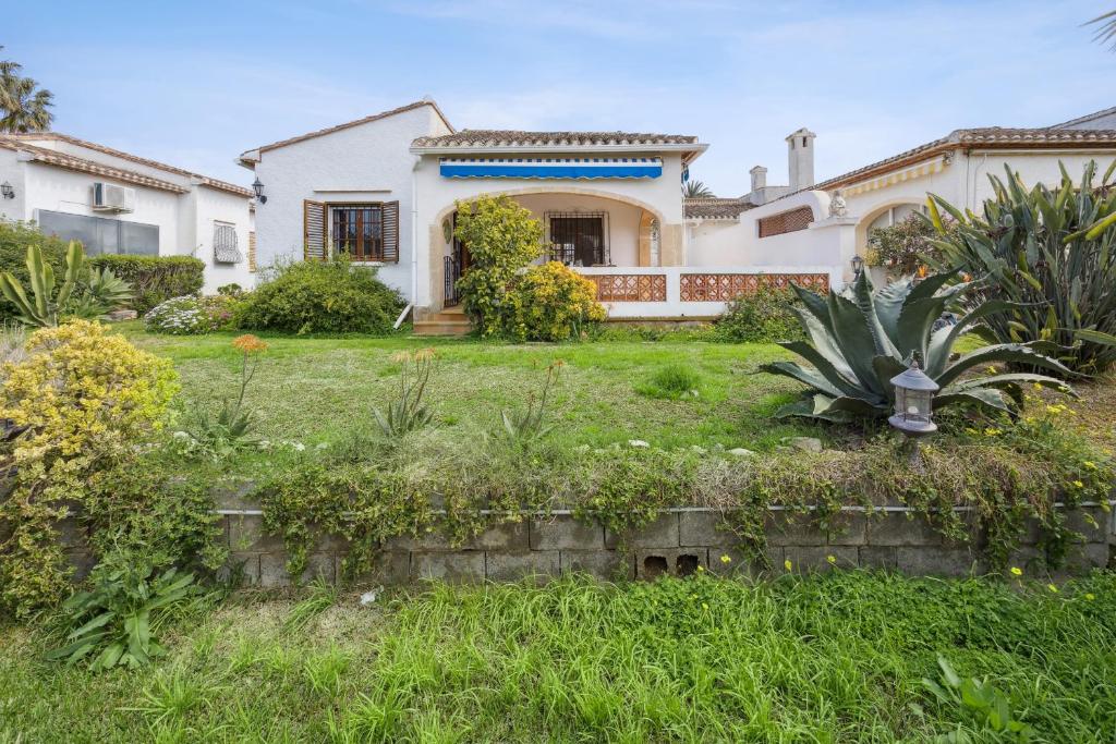 a large white house with a yard at Nuestra Casa in Denia