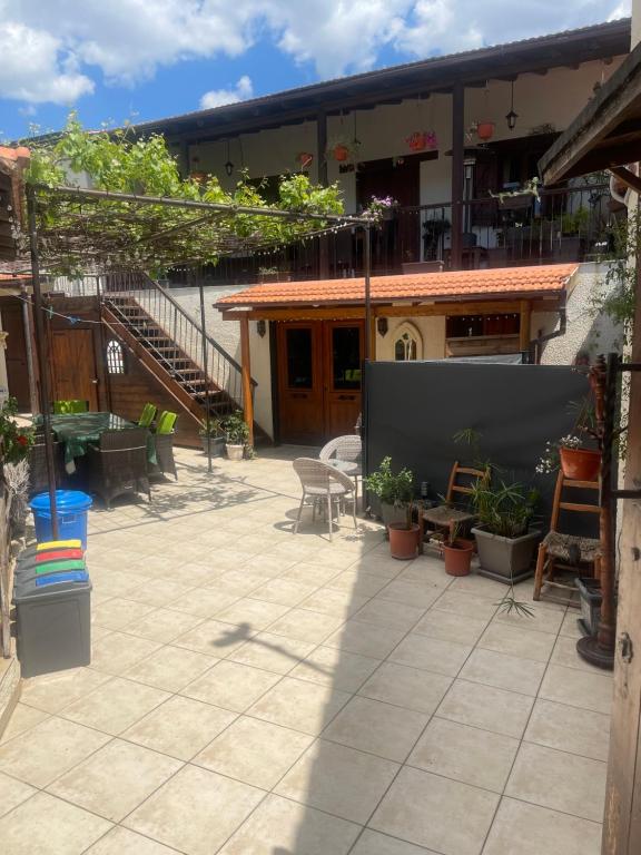 a patio with chairs and tables and a building at Traditional Cypriot House - Akapanou in Akapnou