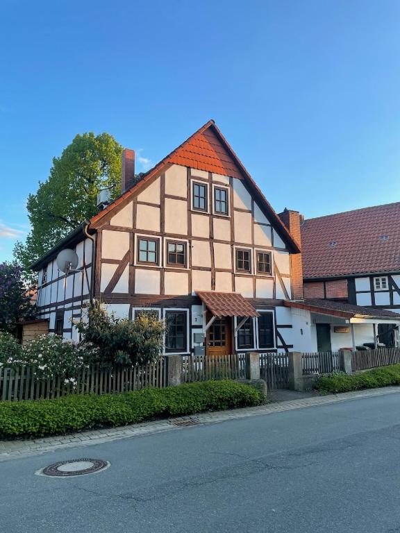 a brown and white house with a fence and a street at Nr7 Das Ferienhaus in Hameln