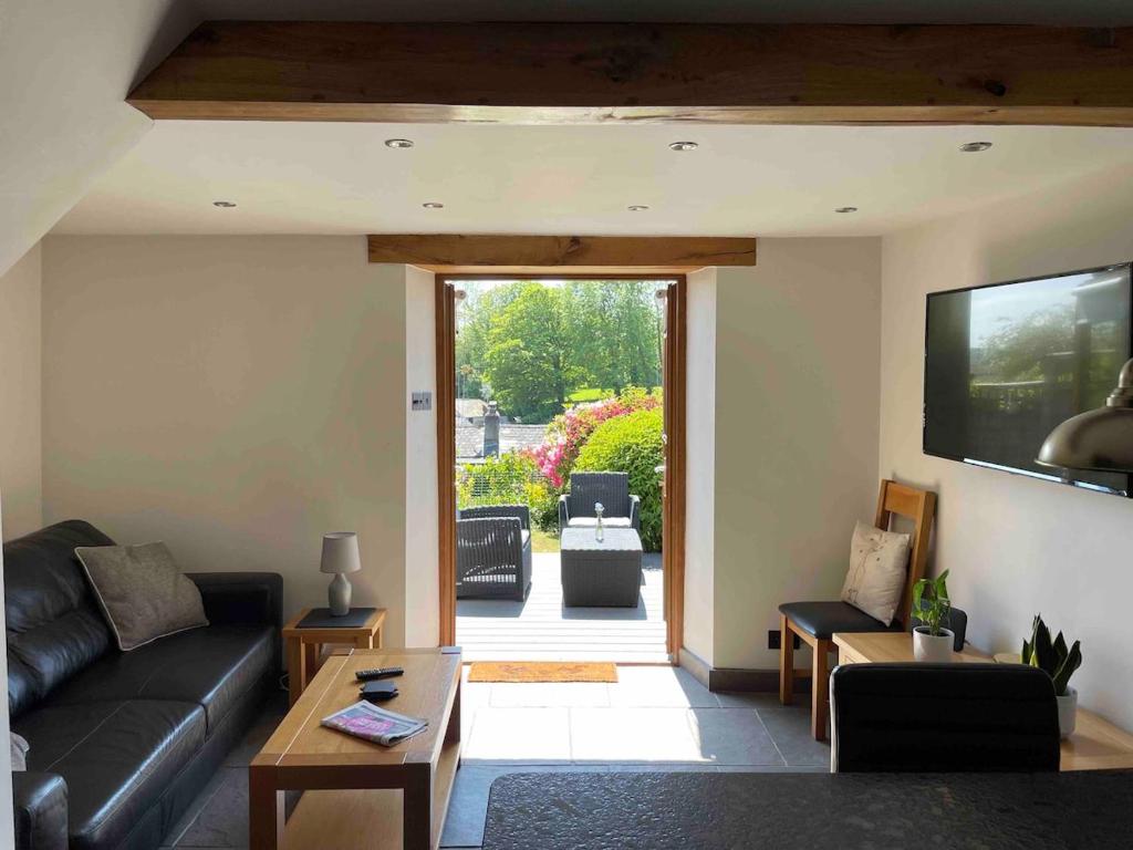 a living room with a couch and a tv at Renovated 2 bed Cottage in Ulverston, Garden with Views in Ulverston