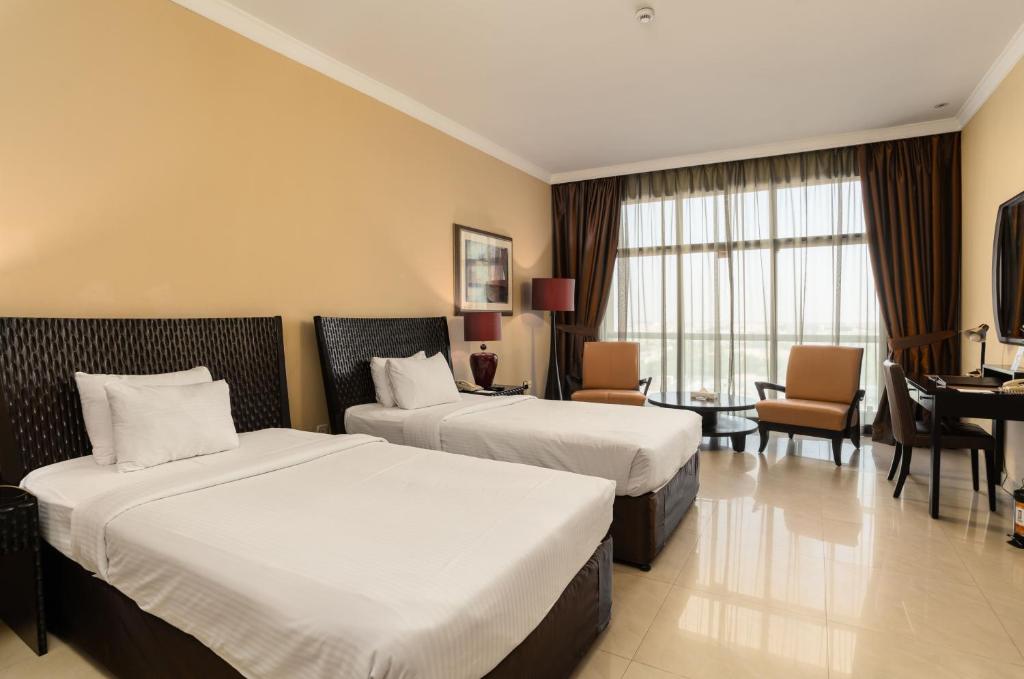 Postel nebo postele na pokoji v ubytování Oryx Hotel