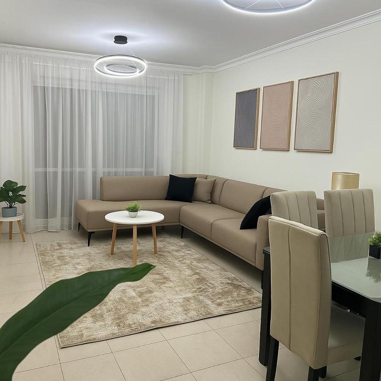 a living room with a couch and a table at Property Sisters Madinaty, Elite garden view B2 in Madinaty