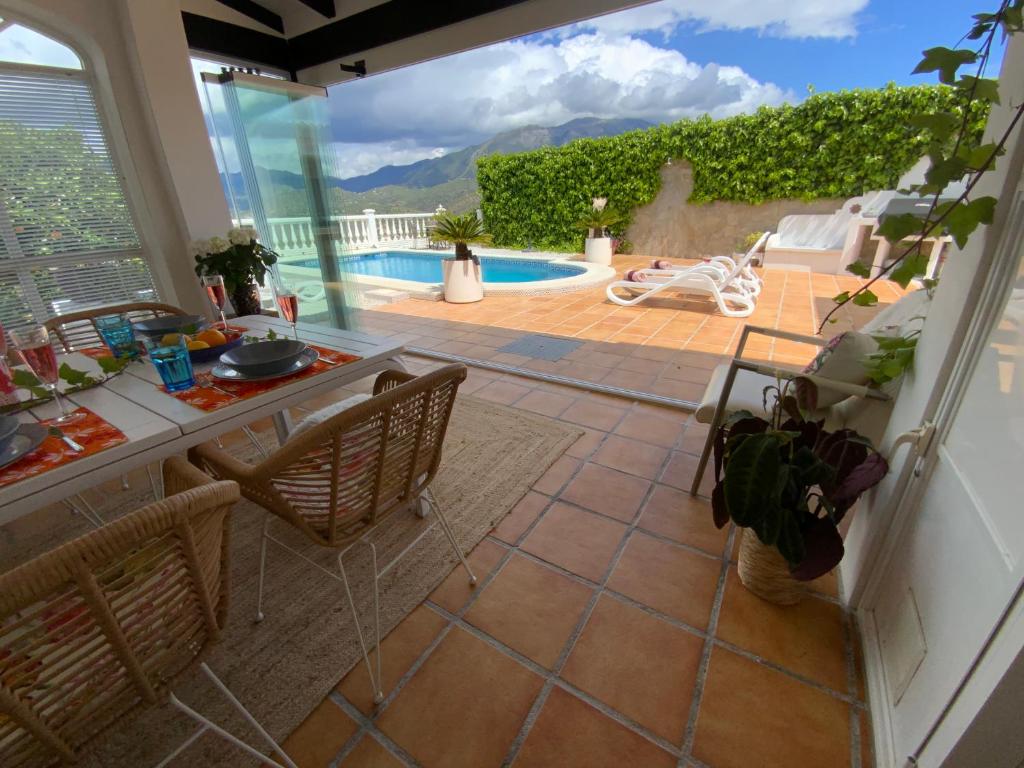 a living room with a view of a swimming pool at Casa Hollandia in Viñuela