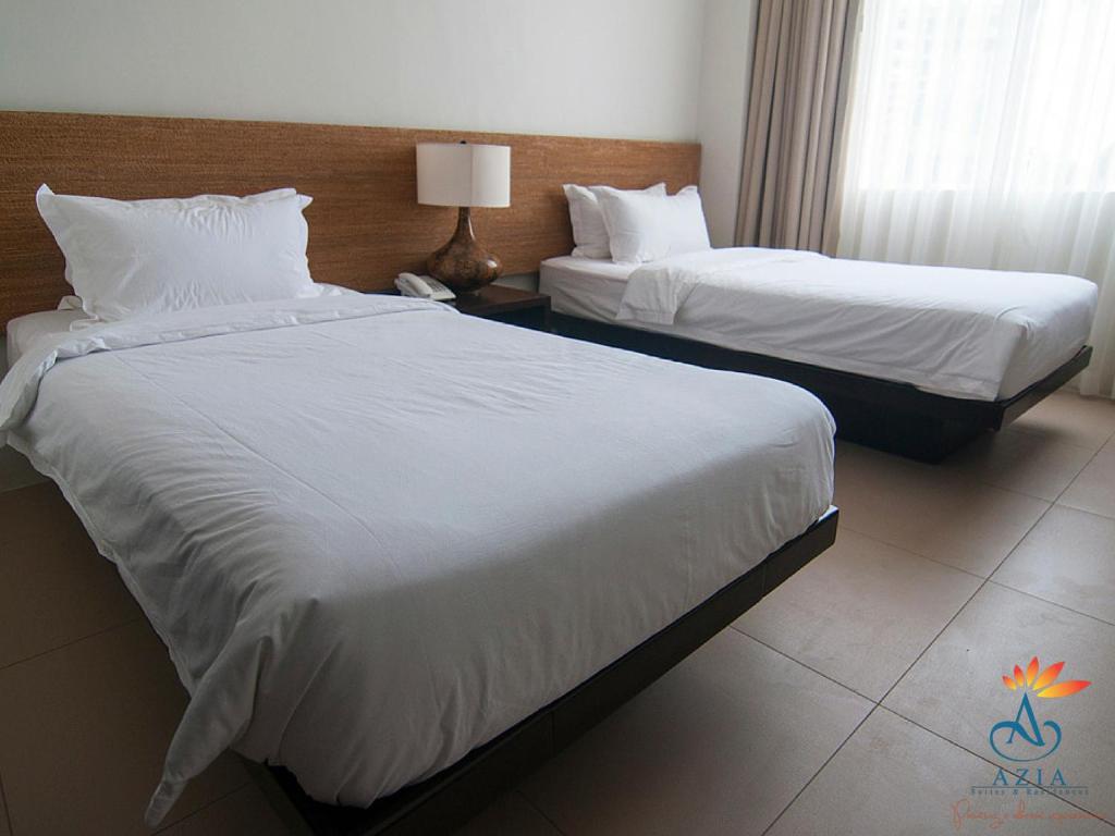 Postel nebo postele na pokoji v ubytování Azia Suites and Residences