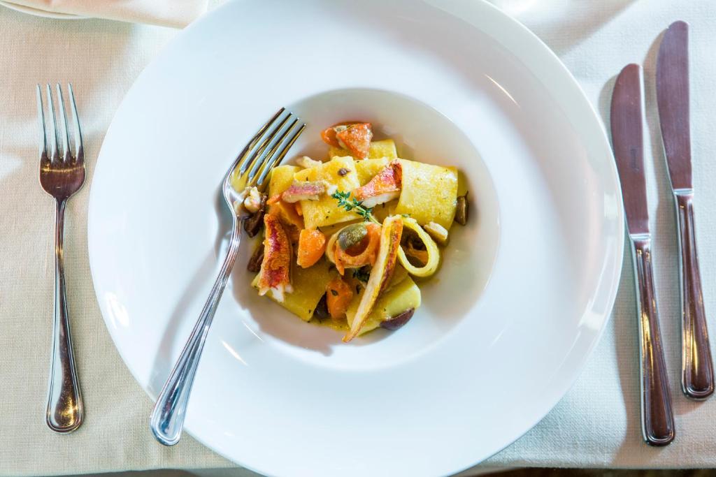 a plate of food with pasta on a table at Hotel Palazzina Grassi in Venice