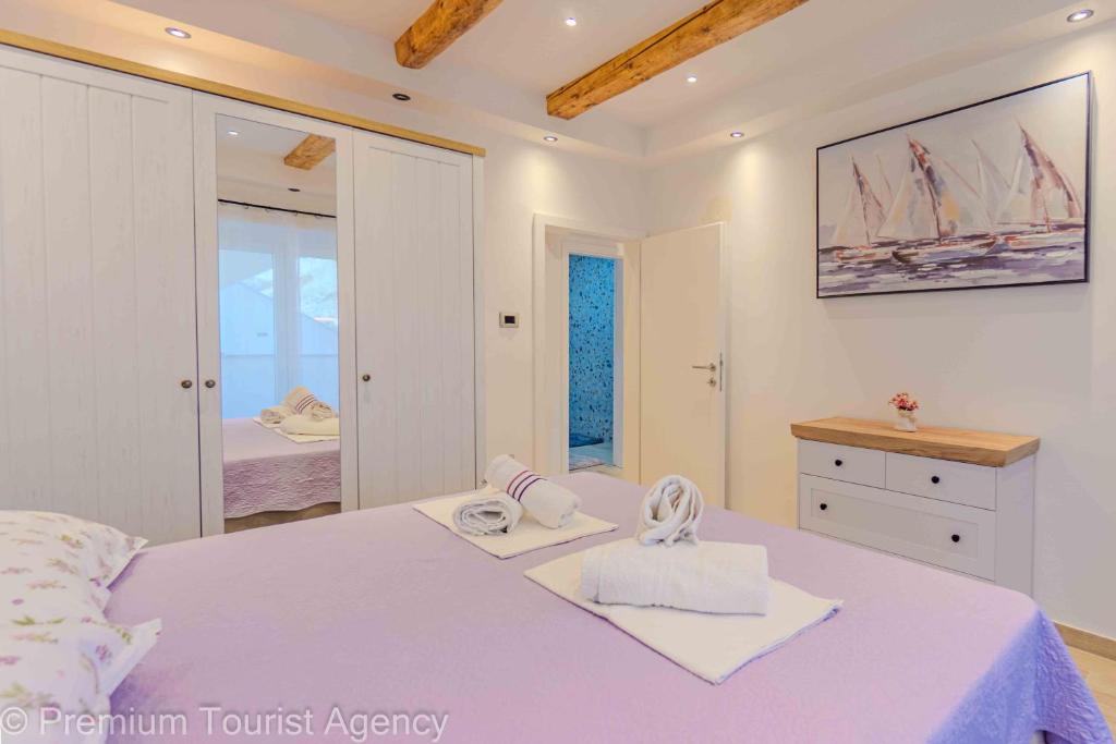 a bedroom with a bed and a large mirror at Toncica Sunny terrace with seaview and shaded BBQ area in Metajna