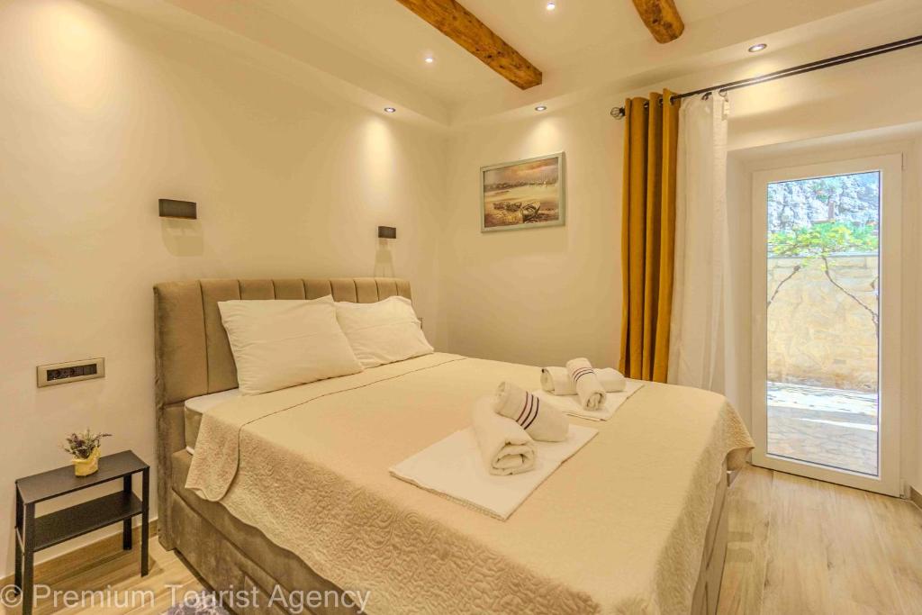 a bedroom with a bed with towels on it at Toncica Sunny terrace with seaview and shaded BBQ area in Metajna